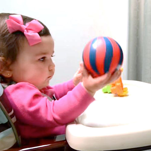 10 month old girl Investigates Ball