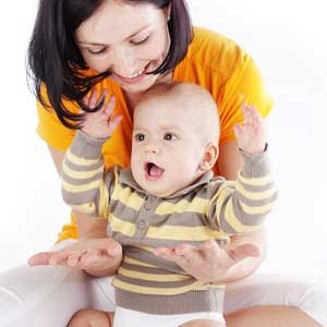Mum and baby clapping and smiling